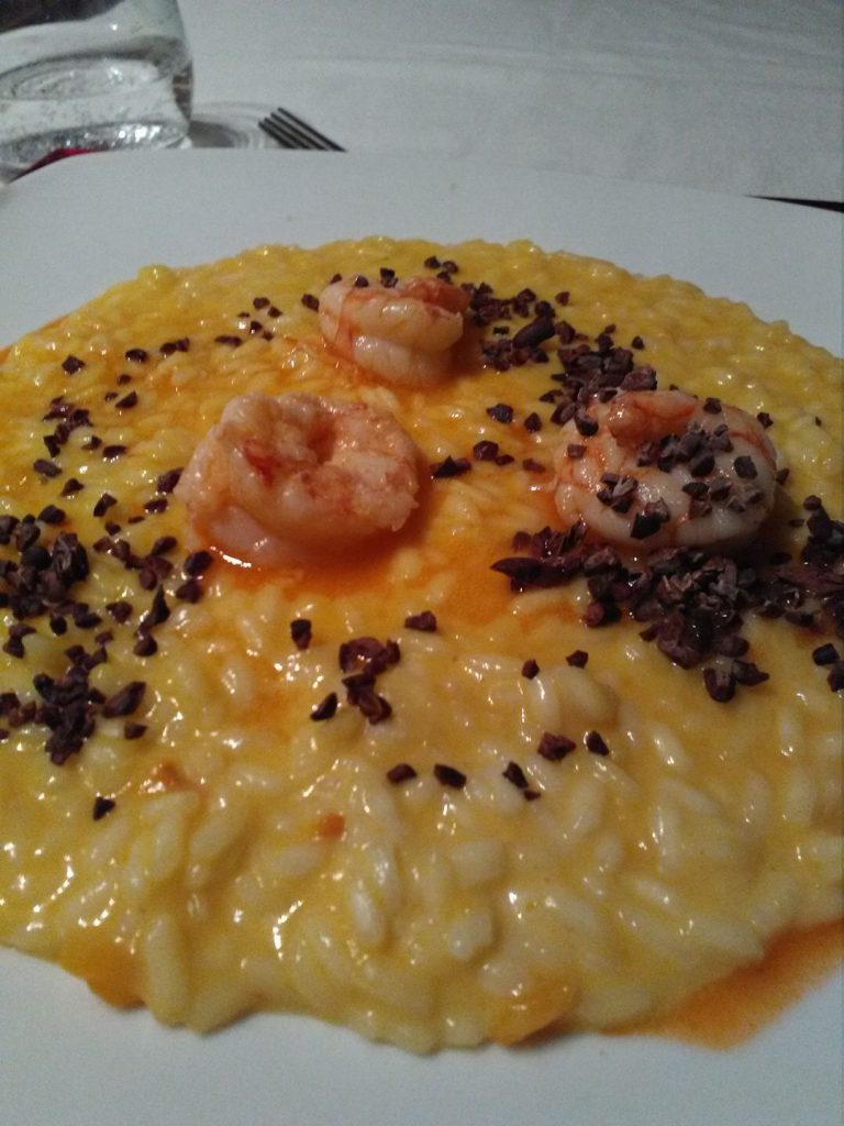Risotto mantecato alla crescenza, zucca, code di gambero e fave di cacao